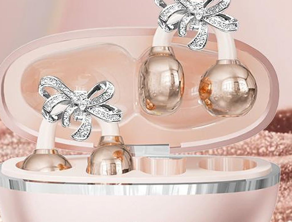 Écouteurs-bijoux Son'elle or rose avec charms nœud, dans leur boîtier
